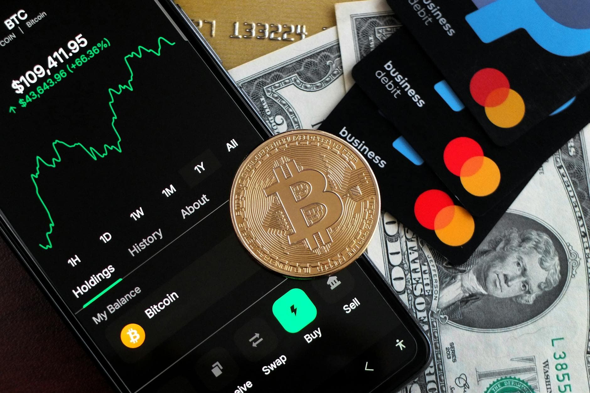 A visual representation of Bitcoin trading and financial transactions with credit cards and cash.