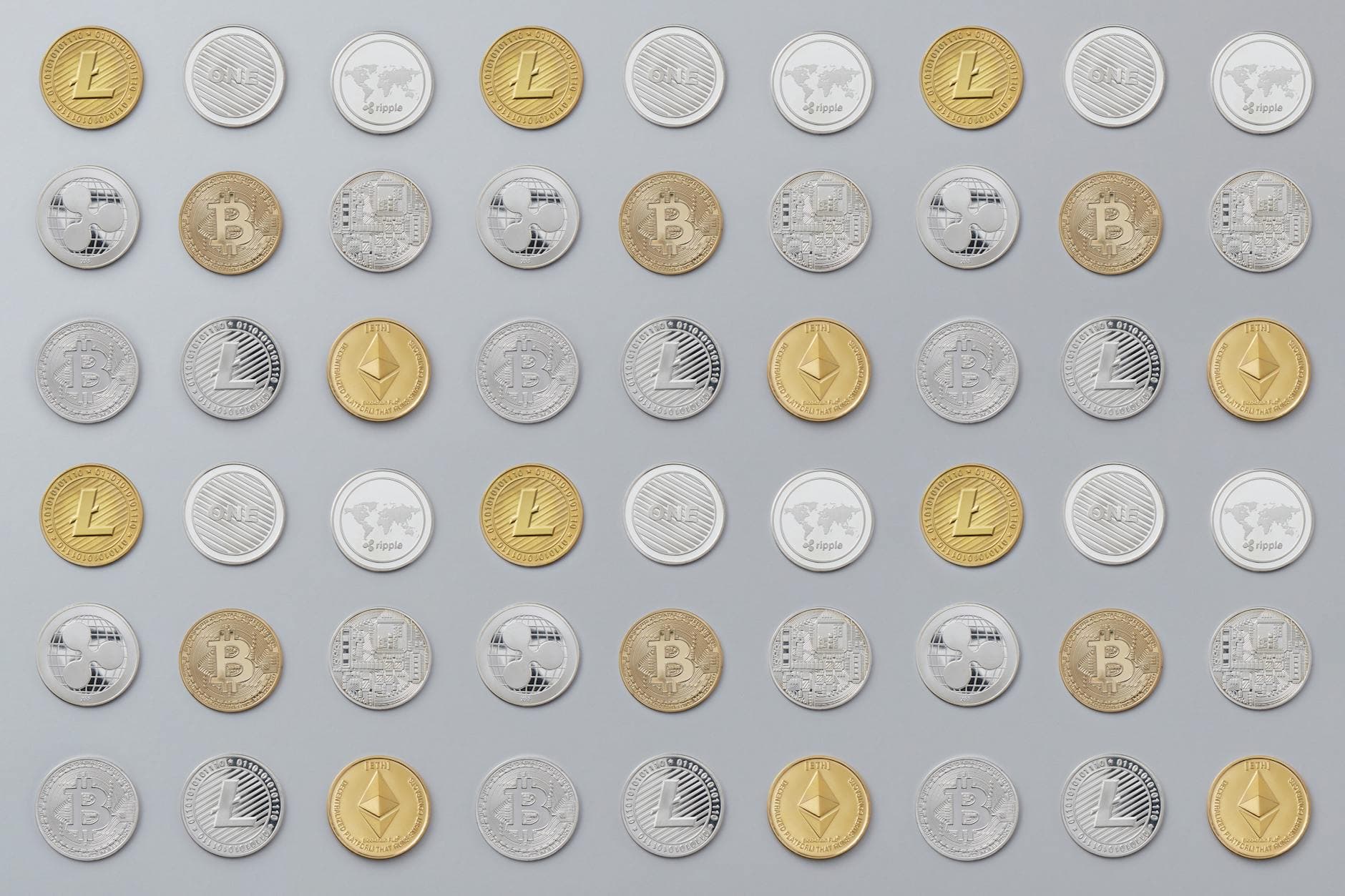 A seamless pattern of various cryptocurrency coins in gold and silver tones.